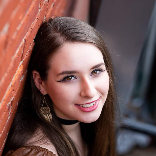 Baylie, a client service specialist at New Horizons, standing outside the office