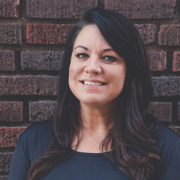 Kasi Costello-O'Brien, a massage therapist at New Horizons, standing outside the office